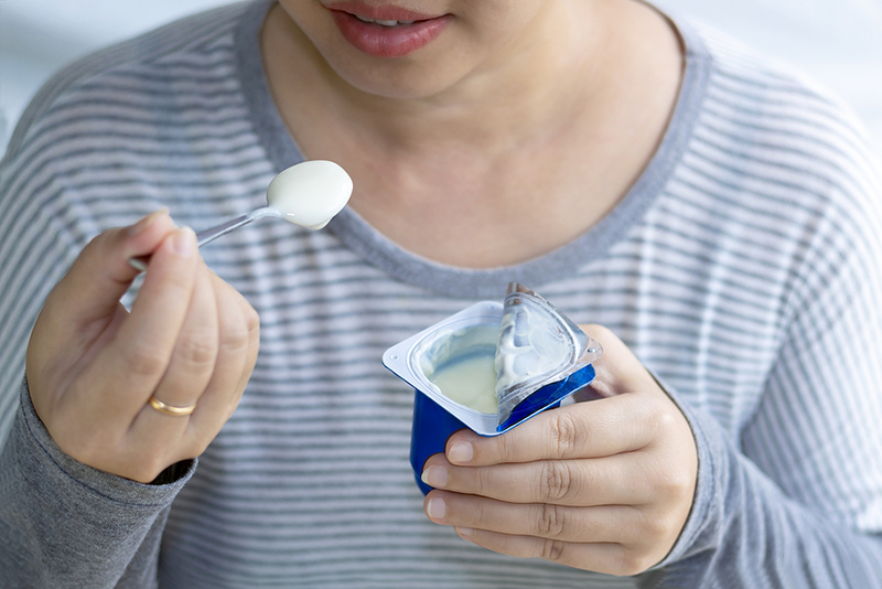 Woman eating yogurt